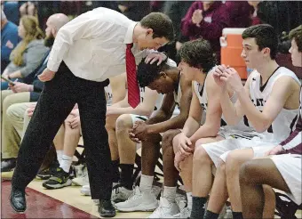  ?? DANA JENSEN/THE DAY ?? East Lyme coach Jeff Bernardi consoles junior Dev Ostrowski in the final moments of the Vikings’ 90-77 loss to Enfield in Saturday’s CIAC Division III boys’ basketball tournament quarterfin­als.