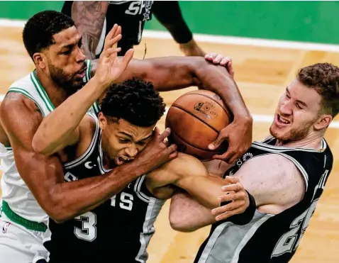  ?? Maddie Malhotra / Getty Images ?? Tristan Thompson, left, battles Keldon Johnson and Jakob Poeltl for a rebound Friday. The Spurs were outscored 95-48 in the second half and OT.