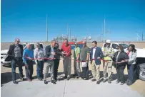  ?? Joe Amon, The Denver Post ?? Vestas president Chris Brown, fourth from left, steps in Tuesday in Matheson to help Alice Jackson, president of PSCo, and Kent Larson, executive vice president of Xcel Energy, cut the ribbon with company and community leaders as they mark the completion of the mammoth Rush Creek Wind Project.