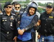  ?? (AP/Sourav Lasker) ?? Mohammed Shahed (center), owner of two hospitals that issued thousands of fake coronaviru­s test reports, is arrested Wednesday in Dhaka, Bangladesh.