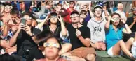  ?? MARIO ANZUONI / REUTERS ?? People watch the solar eclipse on the lawn of Griffith Observator­y in Los Angeles on Monday.