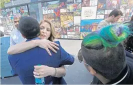  ??  ?? Pulse nightclub owner and onePULSE Foundation founder Barbara Poma is hugged after the unveiling of the the interim memorial to the victims of the 2016 mass shooting.