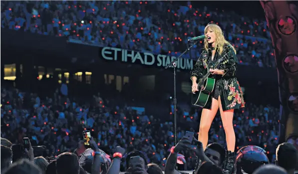  ??  ?? Seeing red: the crowd’s wristbands light up as Taylor Swift immerses herself among 50,000 fans
