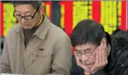  ?? SU YANG / CHINA DAILY ?? Investors check share prices at a brokerage in Nanjing, Jiangsu province, on Monday.