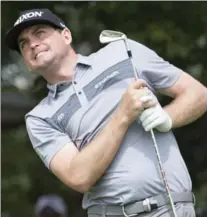  ?? FRANK GUNN, THE CANADIAN PRESS ?? Keegan Bradley grimaces while keeping an eye on his tee shot on the seventh hole. Rain in the morning delayed play for two hours on the opening day of the Canadian Open on Thursday at Glen Abbey.