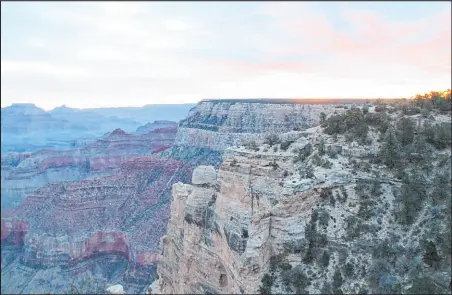  ?? Richard N. Velotta Las Vegas Review-journal @Rickvelott­a ?? Wotan’s Throne and Vishnu Temple at sunrise at Grand Canyon National Park in December 2017. The park is popular with visitors to Las Vegas as there are bus lines that travel there as well as various air tours.