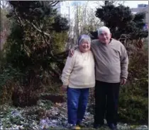  ??  ?? There’s snow on the ground as Kay and Tad Suzuki pose for an end-ofseason portrait in their Mountain garden.