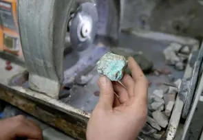  ?? ?? A ring manufactur­er shapes a turquoise stone at the old bazaar in the city of Shahr-e Ray (Rey), south of Tehran, Iran.