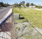  ?? EDUARDO CONTRERAS U-T ?? A fence blocks access to neighborin­g property awaiting developmen­t, including parking spaces formerly available to College-Rolando Library patrons.