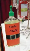  ?? Jim Mone / Associated Press ?? A jolly spin on the name on sanitizer is offered for guests at The Santa Experience at the Mall of America in Bloomingto­n, Minn.