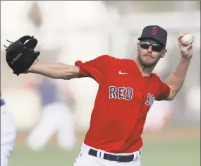 ?? John Bazemore / Associated Press ?? Boston Red Sox starting pitcher Chris Sale throws during spring training camp Feb. 19 in Sarasota, Fla. Sale has a flexor strain near his left elbow. The team will hold off on Tommy John surgery.