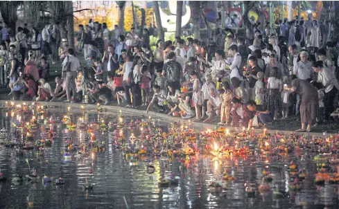  ??  ?? Krathong throng Throngs of people pack Benjasiri Park in the Sukhumvit area where they floated their krathong — a basket laden with coins, candles and their wishes for the future — in its lake. The festival is celebrated across the country. MAIN PHOTO