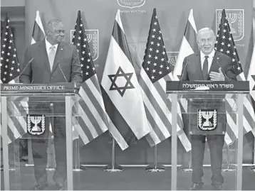  ?? MENAHEM KAHANA/AGENCE FRANCE-PRESSE ?? U.S. Defense Secretary Lloyd Austin, left, and Israeli Prime Minister Benjamin Netanyahu on Monday in Jerusalem. Austin did not mention Iran in his remarks, while Netanyahu barely broached the subject.