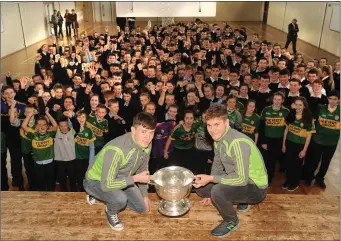  ??  ?? All-Ireland winning Kerry minor footballer­s Mark Ryan and Brian Friel, from Rathmore, brought the Tommy Markham Cup back to their alma mater Scoil Phobail Sliabh Luachra where they received a heroes’ welcome.