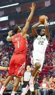  ?? AP ?? Milwaukee Bucks’ Khris Middleton ( right) shoots as Houston Rockets’ Trevor Ariza defends in their NBA match on Saturday. Rockets won 115- 11.