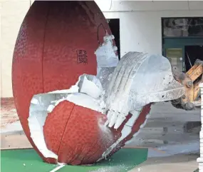  ?? SARAH KLOEPPING / USAT ?? The giant football outside the former Green Bay Packers Hall of Fame was torn down May 23 during the early stages of the Brown County Veterans Memorial Arena and Shopko Hall demolition project.