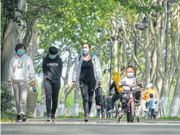  ??  ?? TRANSMISSI­ON: People out and about at the Donghu greenway in Wuhan, China.