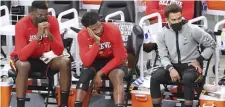  ?? AP ?? TOUGH TO WATCH: From left to right, Atlanta Hawks center Clint Capela, forward Solomon Hill and guard Trae Young watch from the bench in the final minutes