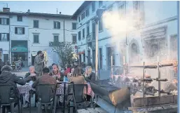  ??  ?? WORKING UP AN APPETITE: Diners tuck in at a street food fair in Campi Bisenzio, just outside Florence, Italy.