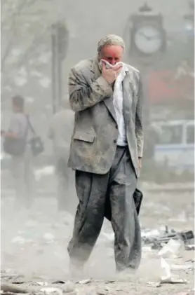  ??  ?? This file photo dated 11 September 2001 shows Edward Fine covering his mouth as he walks through the debris after the collapse of one of the World Trade Center Towers in New York. Fine was on the 78th floor of 1 World Trade Center when it was hit by a hijacked plane on 9/11.
Photo: Stan Honda/AFP