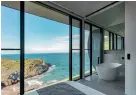  ?? ?? CLOCKWISE FROM LEFT: Take in stunning sea views; Look over Kangaroo Island from the bath and bedrooms; Secluded Naiko Retreat sits in 2000 acres of rolling hills; Relax in the luxurious lounge; The futuristic wellness hub.