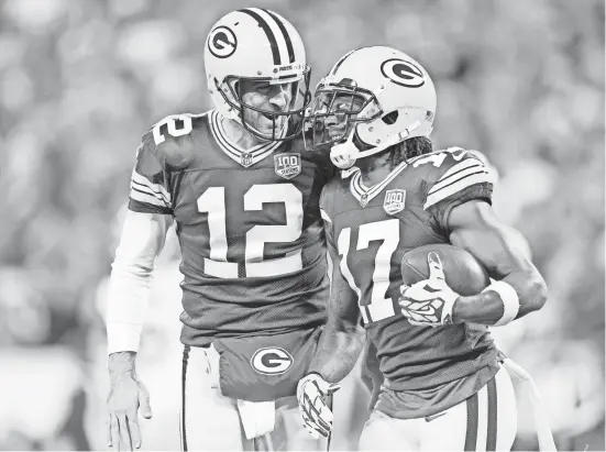  ?? JEFF HANISCH/USA TODAY SPORTS ?? Packers quarterbac­k Aaron Rodgers celebrates with wide receiver Davante Adams (17) after a touchdown.