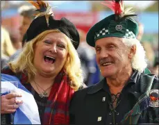  ??  ?? Plumes of patriotism: Scots fans on their way to the game