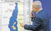  ?? Picture: AFP/ MENAHEM KAHANA ?? MAPPED OUT: Israeli prime minister Benjamin Netanyahu points at a map of the Jordan Valley. He says he will annex the area if he is re-elected in next week’s poll.