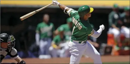  ?? PHOTO/ ?? Oakland Athletics’ Franklin Barreto swings for a three-run home run off Chicago White Sox pitcher Ross Detwiler in the first inning of a baseball game on Saturday, in Oakland. AP BEN MARGOT