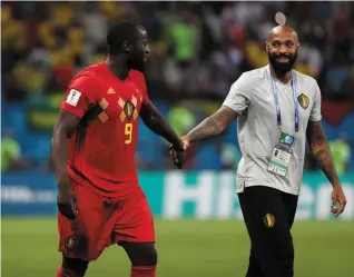  ??  ?? Belgium’s Romelu Lukaku celebrates after the win over Brazil with assistant coach Thierry Henry, who now goes up against the country he won the World Cup with himself after France beat Uruguay to reach the semis, below. Photos: Reuters