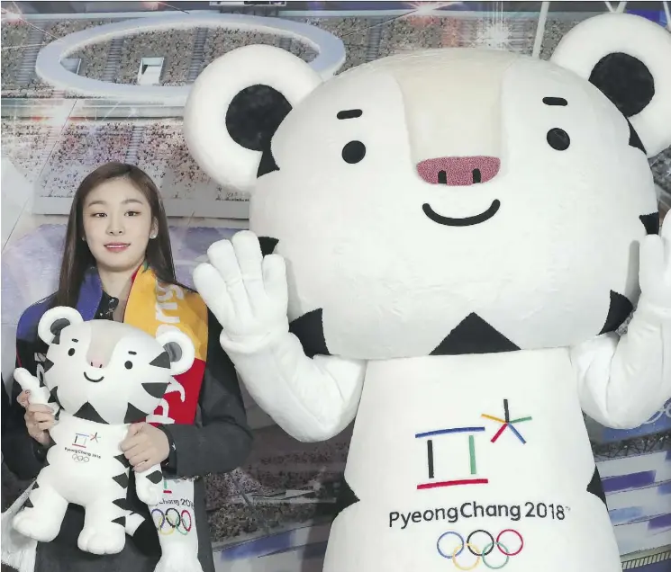  ?? LEE JIN-MAN/THE ASSOCIATED PRESS/FILE ?? Figure skating Olympic gold medallist Yuna Kim, pictured in February, an honorary ambassador for the 2018 Winter Olympics, poses with an official mascot of the PyeongChan­g Games, white tiger Soohorang. With five months to go before the Winter Olympics...