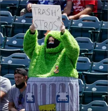  ?? AP PHOTO/MARK J. TERRILL ?? A fan wears an Oscar the Grouch costume as he taunts the Houston Astros prior to a baseball game against the Los Angeles Angels on Tuesday in Anaheim, Calif.