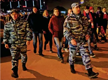  ??  ?? Police escort: Arsenal fans are led to the ground for last night’s Europa game AP