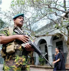  ?? — AFP ?? A Sri Lanka Police Special Task Force (STF) member stands guard near the Supreme Court in Colombo. Sri Lanka’s Supreme Court opened the way for potential impeachmen­t proceeding­s against the president on December 13, ruling that he broke the law by dissolving parliament last month.