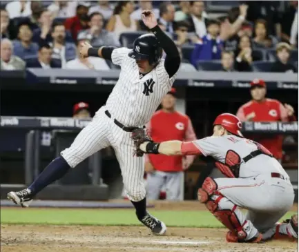  ?? FRANK FRANKLIN II — THE ASSOCIATED PRESS ?? Cincinnati Reds catcher Devin Mesoraco tags out New York Yankees’ Austin Romine at home plate during the fifth inning of the Yankees’ 4-2 win.