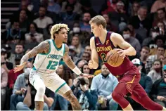  ?? AP Photo/Matt Kelley ?? Charlotte Hornets guard Kelly Oubre Jr. (12) defends Cleveland Cavaliers forward Lauri Markkanen (24) during the first half Monday in Charlotte, N.C.