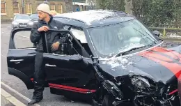  ??  ?? Ant McPartlin climbs out of his wrecked car after smash on Sunday