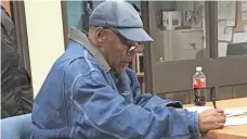  ?? AFP/GETTY IMAGES ?? O.J. Simpson signs documents before leaving Lovelock Correction­al Centre in Nevada on Sunday.