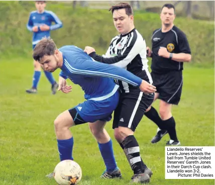  ??  ?? Llandeilo Reserves’ Lewis Jones shields the ball from Tumble United Reserves’ Gareth Jones in their Darch Cup clash. Llandeilo won 3-2.Picture: Phil Davies