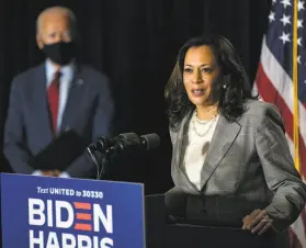  ?? Carolyn Kaster / Associated Press ?? Former Vice President Joe Biden looks on as his choice for running mate, California Sen. Kamala Harris, speaks Thursday at a hotel in Wilmington, Del.