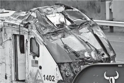  ?? AP Photo/Elaine Thompson ?? The engine from the Amtrak train crash that crashed Monday sits on a transport carrier before being driven away from the scene Wednesday in DuPont, Wash.