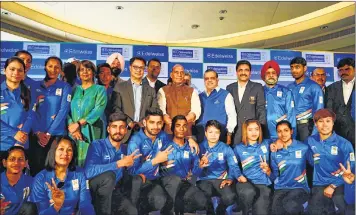  ??  ?? Indian athletes Kiren Rijiju (standing 6L), Rajnath Singh (standing C), Narinder Dhruv Batra (standing 6R) along with other officials during the send-off ceremony for the Indian contingent of the XXI Games Gold Coast 2018 in New Delhi on Thursday.