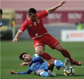  ??  ?? Jurgen Debono (R) of Naxxar Lions is challenged from behind by Mosta's Dexter Xuereb.