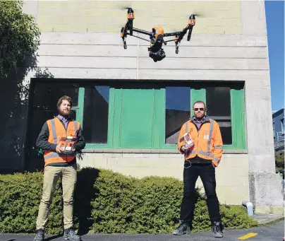  ?? PHOTO: SUPPLIED ?? New approach . . . WSP Opus drone pilot Scott Kvick (left) and senior structural engineer Dave Ellis use a drone to examine the exterior of the University of Otago’s Adams building.