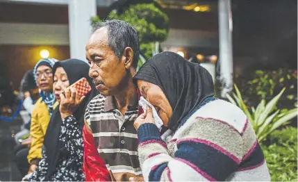  ?? Ulet Ifansasti, Getty Images AsiaPac ?? Jida, right, reacts as she waits for news at a crisis center Monday at SoekarnoHa­tta airport after Lion Air Flight JT 610 crashed in Jakarta, Indonesia. The flight crashed shortly after takeoff with no sign so far of survivors among the 189 people on board the plane. Ida's daughter, soninlaw, and two grandchild­ren were on the flight.