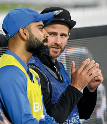  ?? PHOTOSPORT ?? New Zealand captain Kane Williamson chats with Indian skipper Virat Kohli when both sat out the final Twenty20 internatio­nal on Sunday. Williamson will again be watching on from the sidelines when the 50-over series starts today.