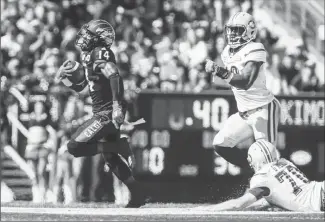  ?? Canadian Press photo ?? Edmonton Eskimos' Christophe Mulumba-Tshimanga, right, and Hugh O'Neill, chase Calgary Stampeders' Roy Finch, left, as he returns a punt for a touchdown during first half CFL football action in Calgary, Monday.