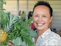  ?? JOSE A. IGLESIAS/MIAMI ?? Thi Squire, community garden project manager of Grow2Heal, shows off some of the produce grown in the garden on June 23 in Homestead, Fla. Homestead Hospital grows its own fruits and vegetables and uses the produce in its cafeteria.