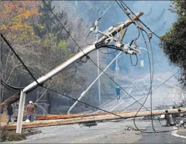  ?? Nhat V. Meyer ?? The Associated Press Two sagging Pacific Gas &amp; Electric power lines made contact, sparked and ignited a Northern California wildfire last year that killed four people and injured a firefighte­r, officials said Tuesday.