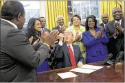  ?? AUDE GUERRUCCI-POOL / GETTY IMAGES ?? U.S. President Donald Trump gives a pen after signing the HBCU Executive Order to support Black Colleges and Universiti­es in the Oval Office of the White House on Tuesday.